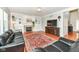 Cozy living room featuring a fireplace, built-in shelves, hardwood floors and a large TV at 14109 Secretariat Ct, Carmel, IN 46074