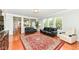 Spacious living room area offering hardwood floors, large windows and an open view to the kitchen at 14109 Secretariat Ct, Carmel, IN 46074