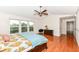 Bright main bedroom with large windows, ceiling fan, and beautiful wood floors at 14109 Secretariat Ct, Carmel, IN 46074