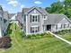 Aerial view of a well-maintained home with manicured lawn, complemented by lush landscaping and mature trees at 14234 Community Dr, Carmel, IN 46033