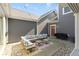 Charming backyard patio with comfortable seating, a grill, and beautiful outdoor lighting at 14234 Community Dr, Carmel, IN 46033