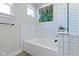 Bright bathroom featuring a soaking tub and glass-enclosed shower at 14234 Community Dr, Carmel, IN 46033