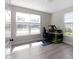 Sunlit bedroom with light gray floors and large windows offering views of the neighborhood, ready for personalization at 14234 Community Dr, Carmel, IN 46033