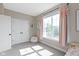 Bright bedroom with large window, white trim and a cozy beanbag chair creates a inviting space for relaxation and play at 14234 Community Dr, Carmel, IN 46033