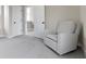 Neutral bedroom featuring a comfortable chair, soft carpeting, bright natural light, and a open doorway for easy access at 14234 Community Dr, Carmel, IN 46033