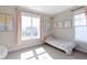 Sunlit bedroom with a large window, pastel artwork, and a cozy bed creating a peaceful and inviting atmosphere at 14234 Community Dr, Carmel, IN 46033