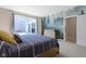 Bedroom with forest themed wall art, patio view, and ensuite entrance at 14234 Community Dr, Carmel, IN 46033