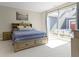 Bedroom with a blue bedspread, art, and patio view at 14234 Community Dr, Carmel, IN 46033