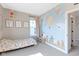 Playful bedroom featuring a charming mural, a cozy bed, and bright natural light, perfect for creative fun and relaxation at 14234 Community Dr, Carmel, IN 46033