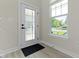 Bright foyer with a window next to the front door, offering natural light and a view of the outdoors at 14234 Community Dr, Carmel, IN 46033