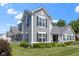Beautifully landscaped home with gray siding and black shutters, offering an inviting curb appeal at 14234 Community Dr, Carmel, IN 46033