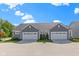 Charming gray home with well-manicured landscaping, double garages, and a welcoming curb appeal, located in a friendly neighborhood at 14234 Community Dr, Carmel, IN 46033