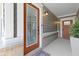 Inviting front door with glass panel, sidelights, and brick accents leading into a welcoming entryway at 14234 Community Dr, Carmel, IN 46033