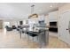 Open concept kitchen with center island, stainless appliances, and breakfast bar overlooking the living space at 14234 Community Dr, Carmel, IN 46033