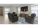 Well-lit living room featuring neutral paint, a flat-screen TV, and modern recliners perfect for relaxation and entertainment at 14234 Community Dr, Carmel, IN 46033