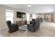 Open living room with recessed lights, neutral paint, and modern furniture seamlessly connecting to the kitchen area at 14234 Community Dr, Carmel, IN 46033