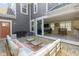 Inviting outdoor patio with comfortable seating and a view into the home's open living space at 14234 Community Dr, Carmel, IN 46033