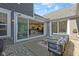 Cozy outdoor patio with seating area, string lights, and view of the open kitchen and living room at 14234 Community Dr, Carmel, IN 46033