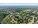 Aerial view of a leafy residential area near a lake and school with easy access to green spaces at 14492 Cotswold Ln, Carmel, IN 46033