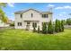 Backyard view of home with a deck, green lawn, landscaping, and white siding at 14492 Cotswold Ln, Carmel, IN 46033
