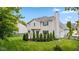 Backyard view of home with patio, tall trees, and landscaping at 14492 Cotswold Ln, Carmel, IN 46033