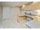 The finished basement includes a built-in desk, overhead lighting, and carpeting, perfect for an office or recreational space at 14492 Cotswold Ln, Carmel, IN 46033