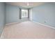 Cozy bedroom with light blue walls, a ceiling fan, and a window for natural light at 14492 Cotswold Ln, Carmel, IN 46033