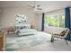 Light and airy bedroom with neutral colors, a ceiling fan, and a large window at 14492 Cotswold Ln, Carmel, IN 46033