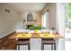 Breakfast bar with stools and a view of the fireplace in the connected Gathering room at 14492 Cotswold Ln, Carmel, IN 46033