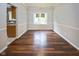 Dining room with hardwood floors and modern lighting fixture at 14492 Cotswold Ln, Carmel, IN 46033