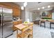 Open concept kitchen with eat-in bar and stainless steel refrigerator at 14492 Cotswold Ln, Carmel, IN 46033