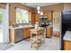Cozy kitchen with stainless steel appliances, center island, and tile flooring at 14492 Cotswold Ln, Carmel, IN 46033