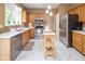 Well-lit kitchen features stainless steel appliances and a convenient mobile island at 14492 Cotswold Ln, Carmel, IN 46033