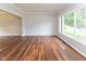 Spacious living area with beautiful hardwood floors, large windows, and neutral paint, creating a bright and airy feel at 14492 Cotswold Ln, Carmel, IN 46033
