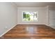 Bright living room features hardwood floors, natural light, and neutral wall paint at 14492 Cotswold Ln, Carmel, IN 46033