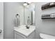 Cozy half-bathroom featuring modern fixtures, neutral paint, and stylish storage solutions at 15178 Silver Charm Dr, Noblesville, IN 46060