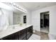 Bright bathroom featuring double sinks, modern lighting, and a spacious walk-in closet at 15178 Silver Charm Dr, Noblesville, IN 46060