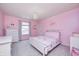 Pink bedroom with chandelier, bed with floral bedding, dresser, and a window with blinds at 15178 Silver Charm Dr, Noblesville, IN 46060