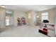 Spacious bonus room perfect for Gathering activities or a playroom, featuring soft carpet and natural light at 15178 Silver Charm Dr, Noblesville, IN 46060