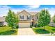 A well-maintained home with a two-car garage, lush green lawn, and mature trees, reflecting suburban charm at 15178 Silver Charm Dr, Noblesville, IN 46060