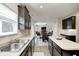 Modern kitchen featuring stainless steel sink, granite countertops and open floor plan to living and dining area at 15178 Silver Charm Dr, Noblesville, IN 46060