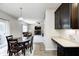 Open kitchen layout flowing to dining area with dark wood cabinets and countertops, perfect for modern living at 15178 Silver Charm Dr, Noblesville, IN 46060