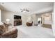 Spacious living room with plush carpet, a cozy fireplace, and stairway access at 15178 Silver Charm Dr, Noblesville, IN 46060