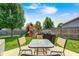 Backyard patio with a table and chairs, and a grill, with a playset visible in the background at 15178 Silver Charm Dr, Noblesville, IN 46060
