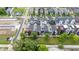 Aerial view of modern townhomes with colorful exteriors, decks, patios, and neatly landscaped green spaces at 1834 Rosette Way, Indianapolis, IN 46202