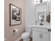 Elegant powder room featuring modern fixtures, stylish wallpaper, and pristine white vanity at 1834 Rosette Way, Indianapolis, IN 46202