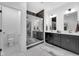Bright bathroom featuring double vanity, walk-in glass shower, tile flooring, and modern fixtures at 1834 Rosette Way, Indianapolis, IN 46202