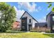 Stylish two-story home featuring gray siding, dark accents, and a fenced-in yard with fresh landscaping at 1834 Rosette Way, Indianapolis, IN 46202