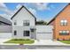Attractive two-story home with a gray exterior, two car garage, covered front entry and second story deck at 1834 Rosette Way, Indianapolis, IN 46202