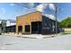 Modern commercial building featuring a wood-paneled facade, black accents, and outdoor seating area at 1834 Rosette Way, Indianapolis, IN 46202